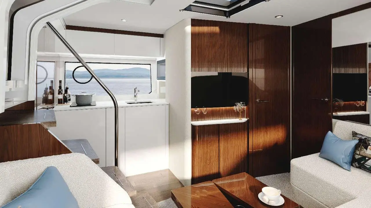 Modern yacht interior featuring a stylish lounge, kitchen area, and large window with sea view. Minimalist design elements visible.